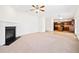 Bright open concept living room and kitchen with fireplace and carpet flooring at 28 Dover Commons Dr, Tucker, GA 30084