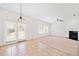 Bright open concept living room with fireplace, ceiling fan, and access to back patio at 28 Dover Commons Dr, Tucker, GA 30084