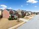 A wide street view showcases a block of attractive two-story brick homes at 28 Dover Commons Dr, Tucker, GA 30084