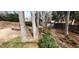 Backyard has mature trees, a rock lined stream bed and terraced mulch garden beds at 2899 Greystone Cv, Chamblee, GA 30341
