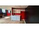 Finished basement area with kitchenette, desk, and light-colored floors at 2899 Greystone Cv, Chamblee, GA 30341