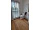 Bathroom featuring hardwood floors, toilet, pedestal sink, and window with blinds at 2899 Greystone Cv, Chamblee, GA 30341