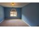 A blue bedroom, offering natural light through a window, with space for customization at 2899 Greystone Cv, Chamblee, GA 30341