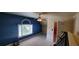 This bedroom is painted a dark blue and features an arched window and ceiling fan at 2899 Greystone Cv, Chamblee, GA 30341