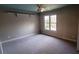 This bedroom features neutral walls, gray carpet, and a ceiling fan for added comfort at 2899 Greystone Cv, Chamblee, GA 30341