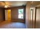 Bedroom with window, fan, and view into the closet, creates a cozy and functional space at 2899 Greystone Cv, Chamblee, GA 30341