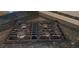 Close-up of a black JennAir cooktop with four burners and black granite countertops at 2899 Greystone Cv, Chamblee, GA 30341