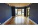 Elegant dining room showcasing blue walls, bay window, and stylish light fixture at 2899 Greystone Cv, Chamblee, GA 30341