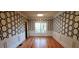 Dining area with hardwood floors and patterned accent wall at 2899 Greystone Cv, Chamblee, GA 30341