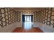 Dining area with hardwood floors and patterned accent wall at 2899 Greystone Cv, Chamblee, GA 30341