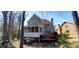 Back of house with screened in porch, deck and wooded area with mature trees at 2899 Greystone Cv, Chamblee, GA 30341