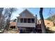 Back of home with a screened porch, outdoor deck, and wooded lot at 2899 Greystone Cv, Chamblee, GA 30341