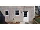 Exterior view featuring a backyard door, windows, and landscaping at 2899 Greystone Cv, Chamblee, GA 30341