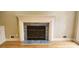 Close up of the cozy fireplace featuring stone surround and wood mantle in the living room at 2899 Greystone Cv, Chamblee, GA 30341