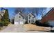 Charming home with mature trees, green landscaping, and two-car garage at 2899 Greystone Cv, Chamblee, GA 30341