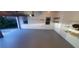 This garage features an epoxy floor and ample natural light for comfortable car care or hobbies at 2899 Greystone Cv, Chamblee, GA 30341
