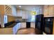 Kitchen boasts white cabinets, black appliances, and granite countertops at 2899 Greystone Cv, Chamblee, GA 30341