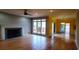 Open-concept living room with fireplace and large windows leading to an outdoor deck area, great for entertaining at 2899 Greystone Cv, Chamblee, GA 30341
