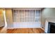 Spacious living room featuring built-in bookshelves, fireplace, and hardwood floors throughout the home at 2899 Greystone Cv, Chamblee, GA 30341