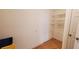 Pantry with white metal shelving and light hardwood floors at 2899 Greystone Cv, Chamblee, GA 30341