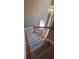 Carpeted staircase featuring wood railing, balusters and decorative light fixture, adding elegance to the home's design at 2899 Greystone Cv, Chamblee, GA 30341