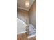 Hardwood staircase featuring white railing, balusters and decorative light fixture, adding elegance to the home's design at 2899 Greystone Cv, Chamblee, GA 30341