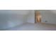 Finished attic space with neutral carpet and trim, with a dormer, closet, and vent at 83 Malcom Rd, Covington, GA 30014