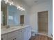 Well-lit bathroom featuring a double vanity with white cabinets and wood-look flooring at 83 Malcom Rd, Covington, GA 30014