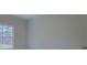 Bright bedroom with a window and light-colored carpet. Doorway is partially visible at 83 Malcom Rd, Covington, GA 30014
