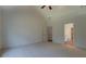 A spacious carpeted bedroom with a fan and two doorways, one leading to a private bathroom at 83 Malcom Rd, Covington, GA 30014