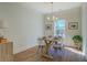 Bright dining room features a wooden table, modern light fixture, and large window for natural light at 83 Malcom Rd, Covington, GA 30014