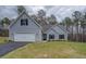 Charming single-Gathering home features a two-car garage, light gray siding, manicured lawn, and black shutters at 83 Malcom Rd, Covington, GA 30014