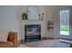 Cozy fireplace is accented with a large mirror, decorative ladder, and an exit to the back yard at 83 Malcom Rd, Covington, GA 30014