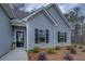 Charming home exterior with gray siding, dark shutters, and manicured front yard at 83 Malcom Rd, Covington, GA 30014