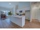 Spacious kitchen featuring white cabinets, countertops, wood floors, and modern stainless steel appliances at 83 Malcom Rd, Covington, GA 30014