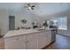 Modern kitchen boasts an island with a sink, white cabinetry, and an open layout to the living room at 83 Malcom Rd, Covington, GA 30014