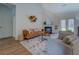 Bright living room includes vaulted ceilings, wood floors, fireplace, and access to the backyard with double doors at 83 Malcom Rd, Covington, GA 30014