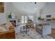 Inviting living room with vaulted ceilings, a fireplace, and an open layout to the kitchen and backyard at 83 Malcom Rd, Covington, GA 30014