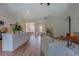 Bright living room with modern decor, wood floors, and an open floor plan leading to the kitchen at 83 Malcom Rd, Covington, GA 30014