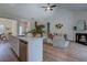 Open-concept living room boasts a modern fireplace, ceiling fan, and wood-style flooring at 83 Malcom Rd, Covington, GA 30014