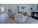 Open-concept living room features wood floors, a cozy fireplace, and stylish decor with plenty of seating at 83 Malcom Rd, Covington, GA 30014