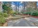 Landscaped backyard with garden beds, stone walking path, and small stone fountain at 1194 Kendrick Ne Rd, Atlanta, GA 30319