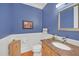 Stylish powder room with blue walls, wainscoting, and custom vanity at 1194 Kendrick Ne Rd, Atlanta, GA 30319