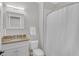 Bright bathroom featuring a granite vanity, toilet, and shower-tub combination at 1194 Kendrick Ne Rd, Atlanta, GA 30319