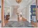 Grand foyer with slate tile flooring, staircase, and elegant chandelier at 1194 Kendrick Ne Rd, Atlanta, GA 30319