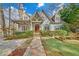 Charming home with a stone pathway, lush landscaping, and a welcoming front porch at 1194 Kendrick Ne Rd, Atlanta, GA 30319