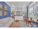 Cozy sitting room with custom built-in bookshelves, tufted ottoman, and ample natural light at 1194 Kendrick Ne Rd, Atlanta, GA 30319