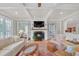 Bright living room featuring a fireplace, shiplap, and French doors at 1194 Kendrick Ne Rd, Atlanta, GA 30319