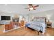 Spacious main bedroom with sitting area, fireplace, wood floors, and ceiling fan at 1194 Kendrick Ne Rd, Atlanta, GA 30319