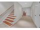 Hallway with hardwood staircase and carpeted floor leading to a door and built-in storage at 1194 Kendrick Ne Rd, Atlanta, GA 30319